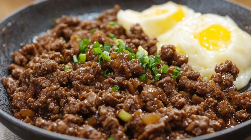 Savory ground beef bulgogi cooked with garlic, soy sauce, and sesame oil, served over steamed rice and garnished with green onions and sesame seeds